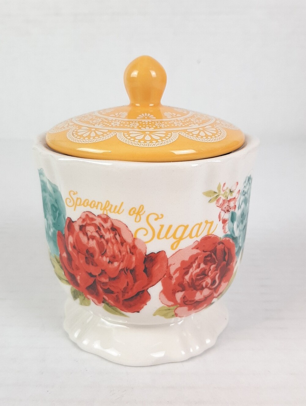 The Pioneer Woman Blossom Jubilee stoneware sugar bowl with a yellow lid.